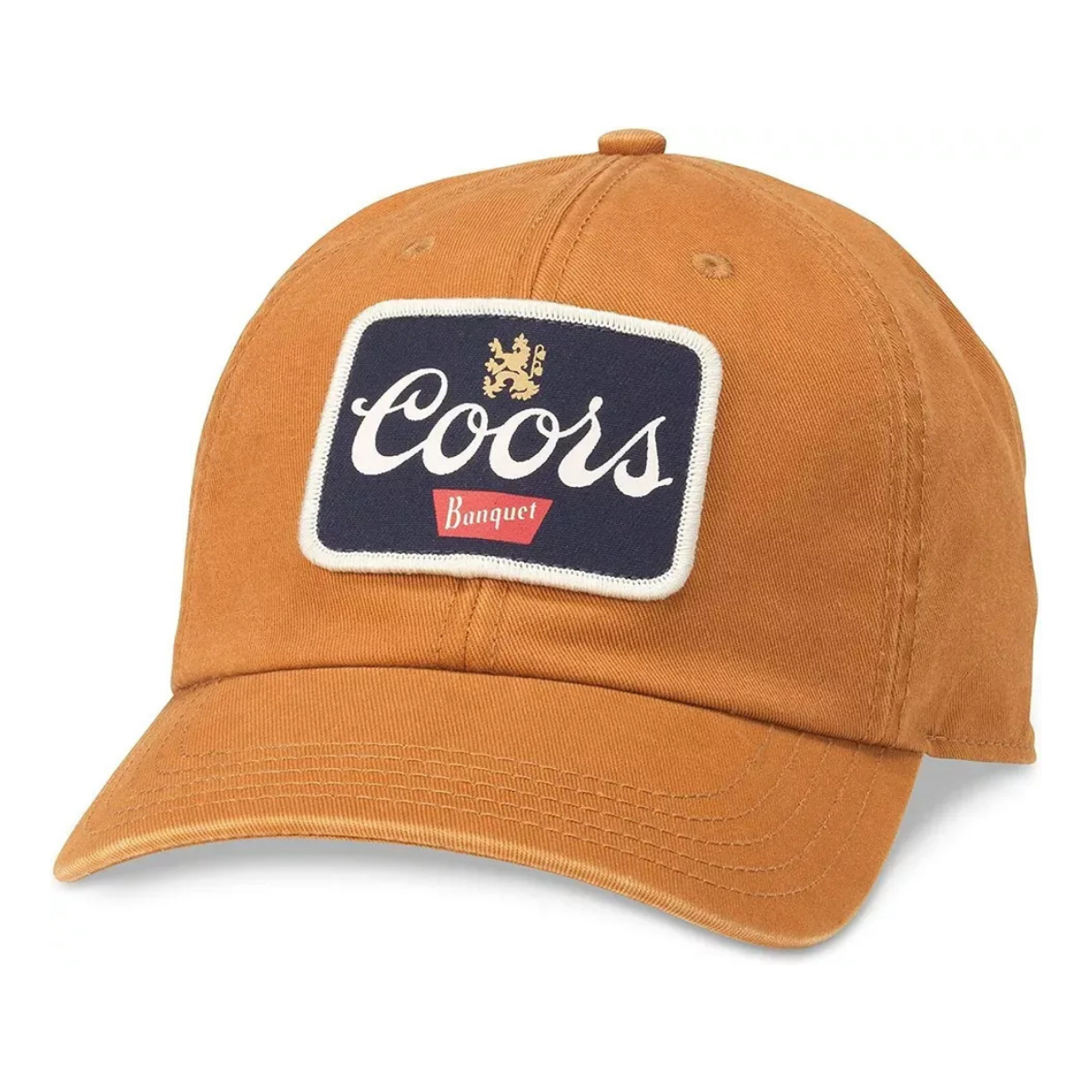 A Coors Banquet baseball cap in a washed tan color, featuring a navy blue embroidered front patch with white Coors script, a gold crest, and a red Banquet label.